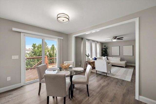 dining area with baseboards and wood finished floors