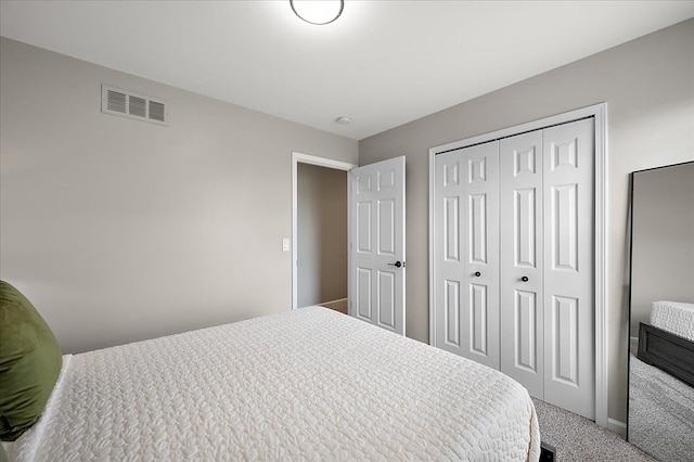 bedroom with carpet floors, baseboards, a closet, and visible vents