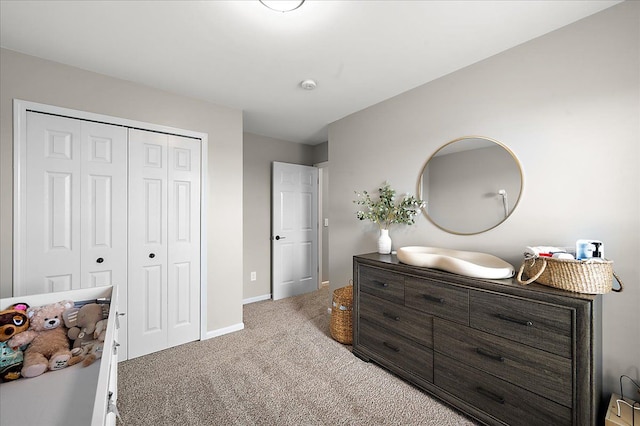 bedroom with carpet floors, baseboards, and a closet