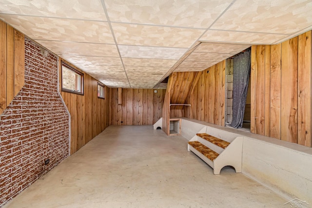 below grade area featuring wooden walls and stairway