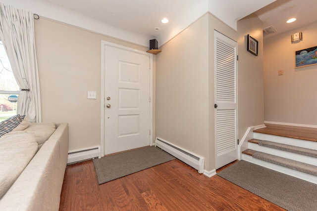 foyer with visible vents, a baseboard radiator, wood finished floors, and recessed lighting