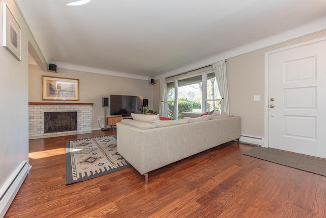 living area with a fireplace, a baseboard heating unit, wood finished floors, and a baseboard radiator