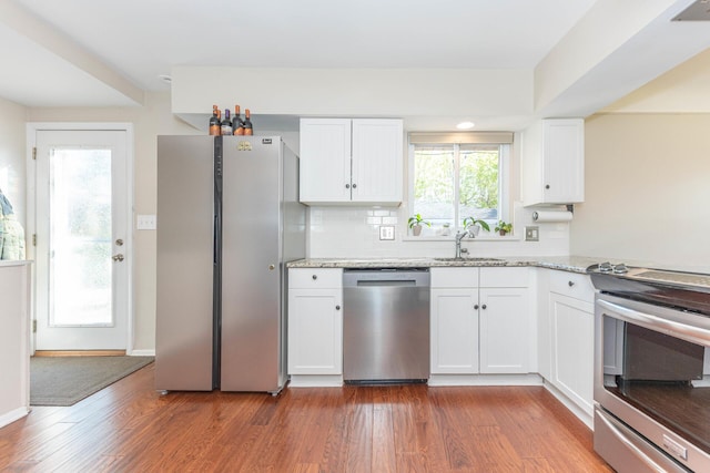 kitchen featuring a sink, dark wood-style flooring, white cabinetry, and stainless steel appliances