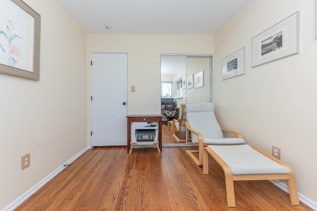 sitting room featuring baseboards and wood finished floors