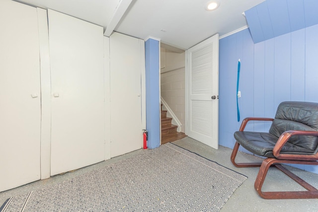 sitting room with speckled floor and stairway