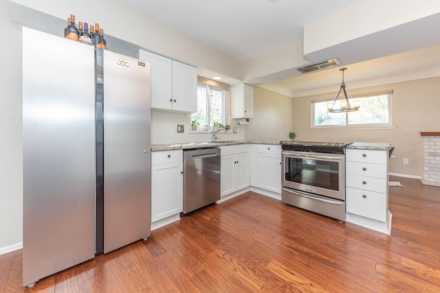 kitchen featuring visible vents, baseboards, white cabinetry, dark wood finished floors, and appliances with stainless steel finishes