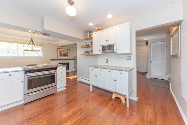 kitchen with white cabinets, stainless steel appliances, open shelves, and light wood finished floors