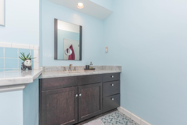 bathroom featuring recessed lighting, baseboards, and vanity