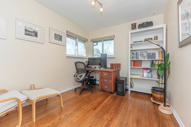office area featuring baseboards and wood finished floors