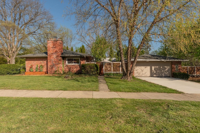 ranch-style home featuring brick siding, a garage, a front yard, a chimney, and driveway