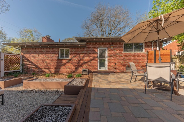 view of patio with outdoor dining area and fence
