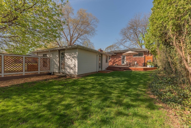 view of yard with a wooden deck and fence