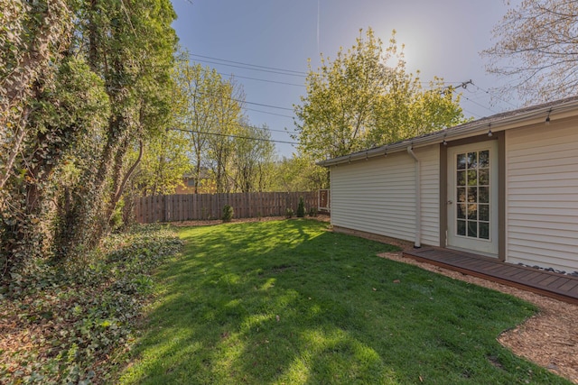 view of yard featuring fence and a deck