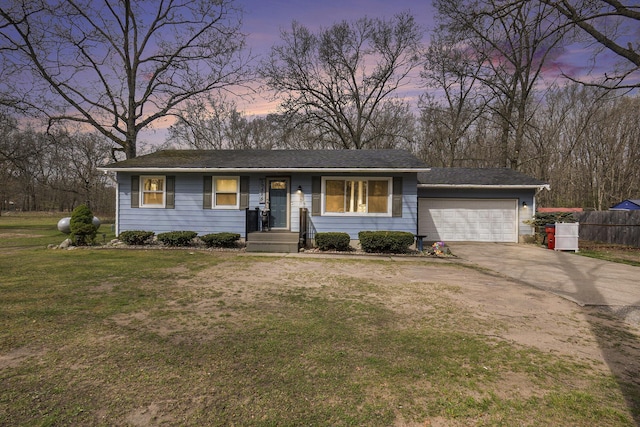 single story home featuring an attached garage, a yard, driveway, and fence
