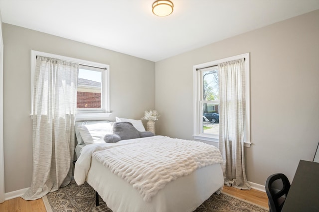 bedroom featuring baseboards and light wood-style flooring