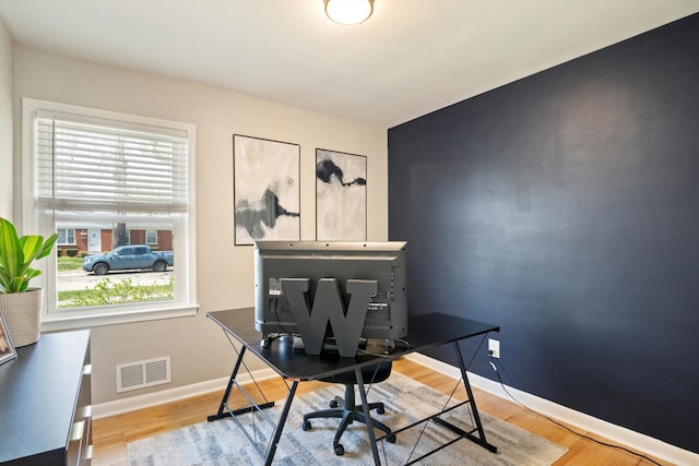 office featuring visible vents, baseboards, and wood finished floors