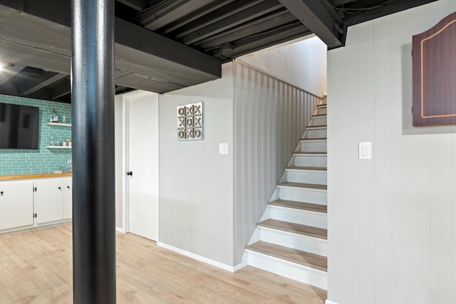 stairs with baseboards and wood finished floors