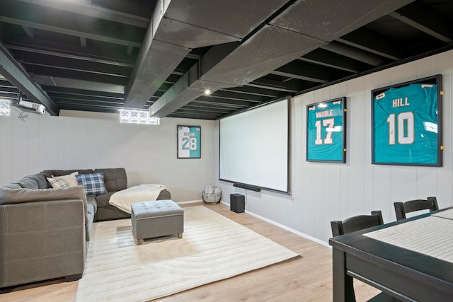 cinema room with baseboards and wood finished floors