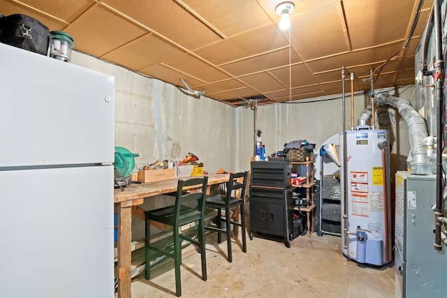 unfinished basement featuring freestanding refrigerator and gas water heater