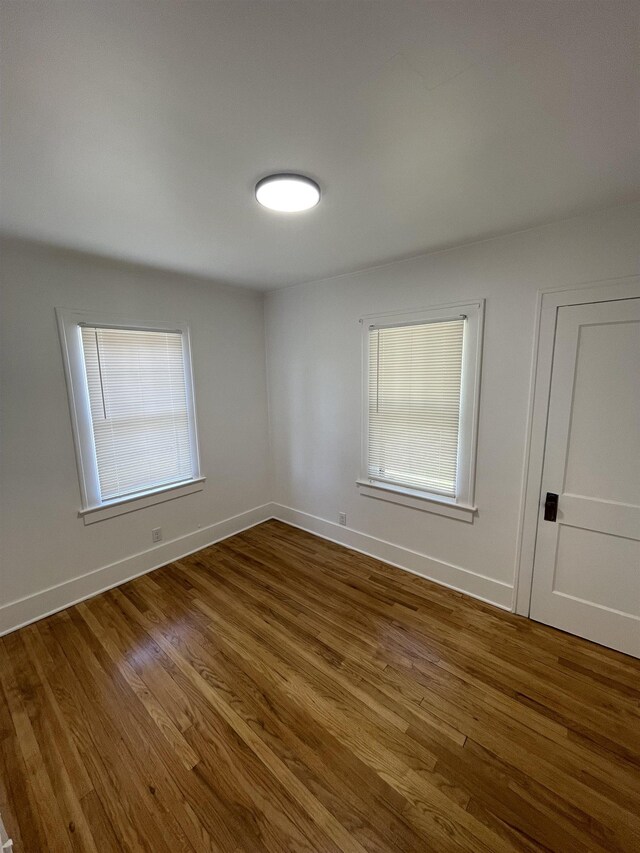 2314 Begole St, Flint, MI 48504 - empty room with dark wood finished floors and baseboards