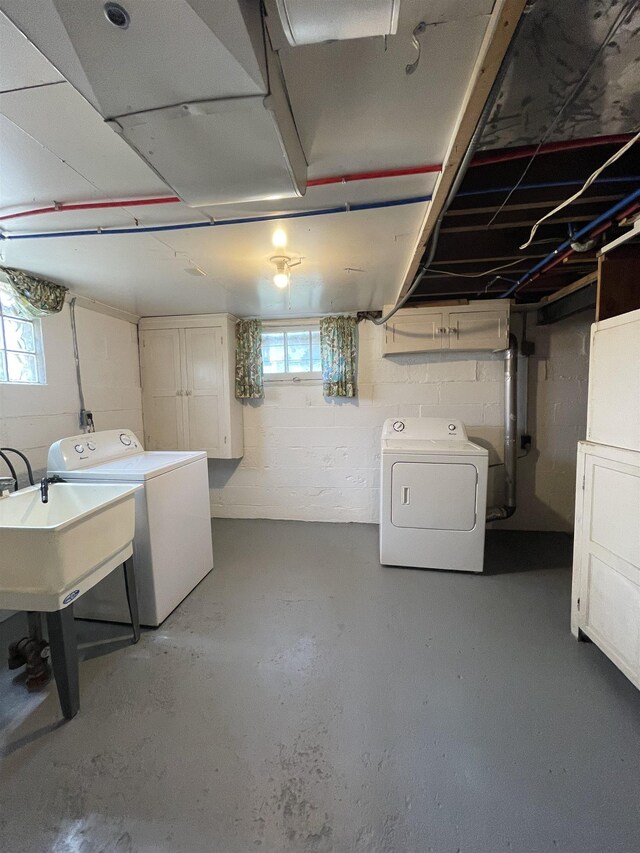 2314 Begole St, Flint, MI 48504 - basement featuring washing machine and dryer and concrete block wall