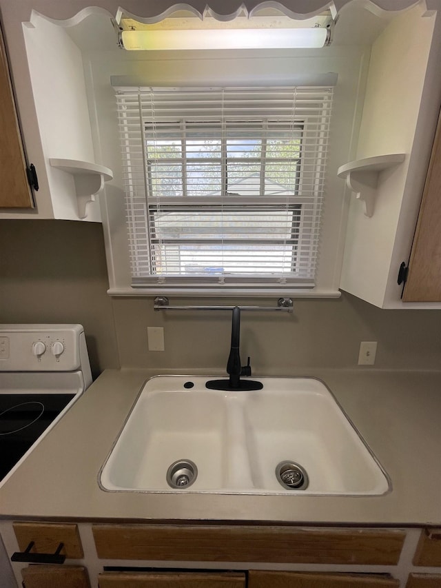 2314 Begole St, Flint, MI 48504 - kitchen featuring open shelves, a sink, white electric stove, and light countertops