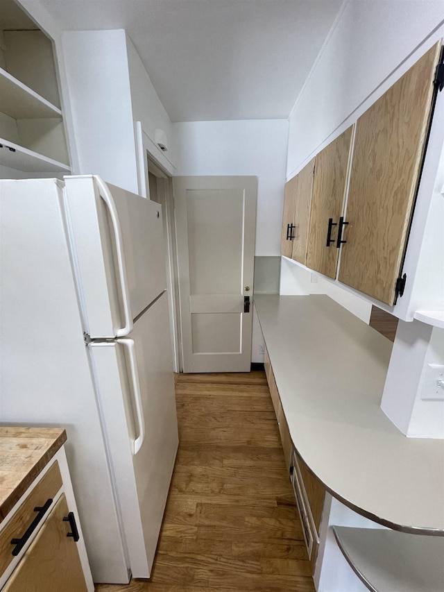 2314 Begole St, Flint, MI 48504 - kitchen featuring freestanding refrigerator, wood finished floors, and light countertops
