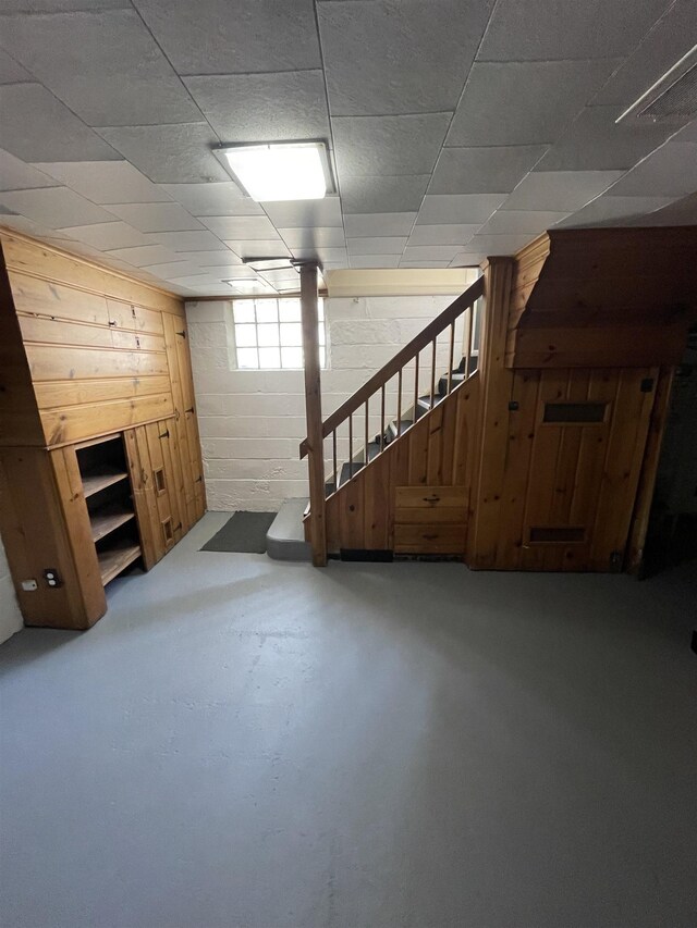 2314 Begole St, Flint, MI 48504 - below grade area with stairs, concrete block wall, and wood walls