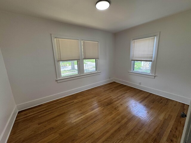 2314 Begole St, Flint, MI 48504 - empty room featuring baseboards and wood finished floors