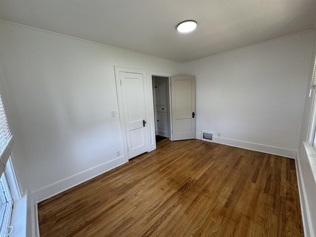 2314 Begole St, Flint, MI 48504 - unfurnished bedroom with wood finished floors and baseboards