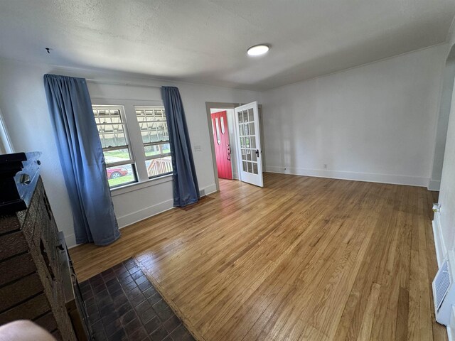2314 Begole St, Flint, MI 48504 - spare room with wood finished floors, baseboards, and french doors