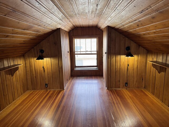 2314 Begole St, Flint, MI 48504 - additional living space with wood-type flooring, lofted ceiling, and wood walls
