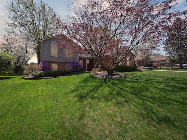 view of front of house with brick siding and a front yard