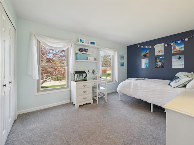 bedroom featuring baseboards, a closet, and carpet flooring