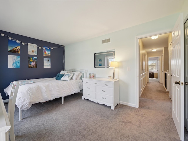 bedroom featuring baseboards, visible vents, and light colored carpet