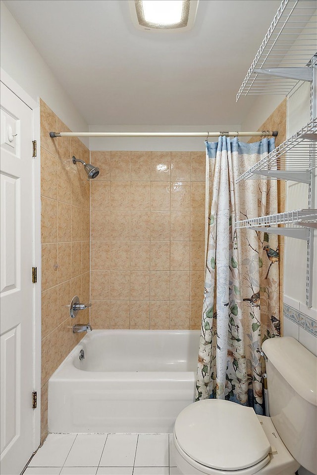 full bathroom featuring tile patterned flooring, shower / bath combo, and toilet