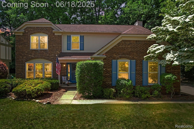 1710 Dawncrest Dr, West Bloomfield, MI 48324 - traditional home featuring brick siding, a chimney, a front lawn, and a shingled roof