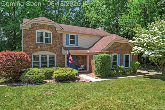 1710 Dawncrest Dr, West Bloomfield, MI 48324 - traditional home with a front yard, brick siding, a chimney, and roof with shingles