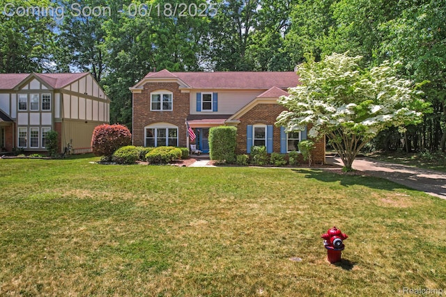 1710 Dawncrest Dr, West Bloomfield, MI 48324 - view of front facade with brick siding and a front yard