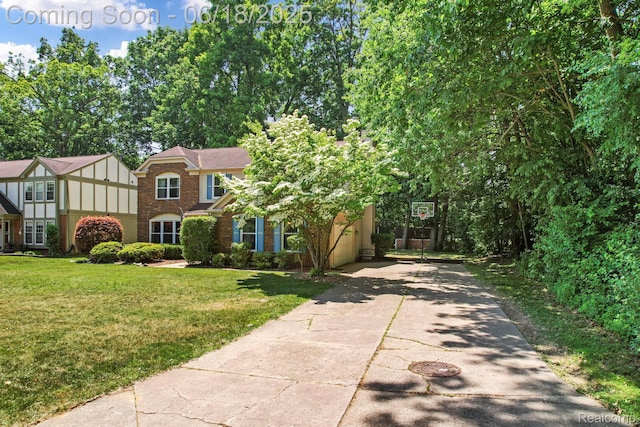 1710 Dawncrest Dr, West Bloomfield, MI 48324 - view of front of property with a front lawn, brick siding, and concrete driveway