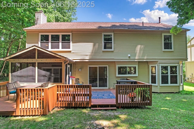 1710 Dawncrest Dr, West Bloomfield, MI 48324 - rear view of house with a chimney, a sunroom, a wooden deck, a lawn, and roof with shingles