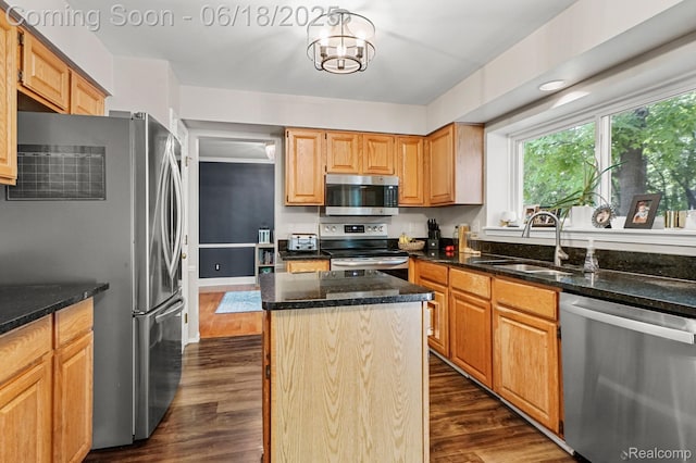 1710 Dawncrest Dr, West Bloomfield, MI 48324 - kitchen featuring stainless steel appliances, dark wood finished floors, a kitchen island, and dark stone counters