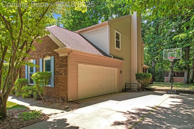 1710 Dawncrest Dr, West Bloomfield, MI 48324 - view of side of property with a chimney, driveway, a garage, brick siding, and roof with shingles