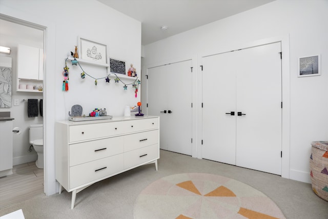 bedroom with multiple closets and ensuite bath