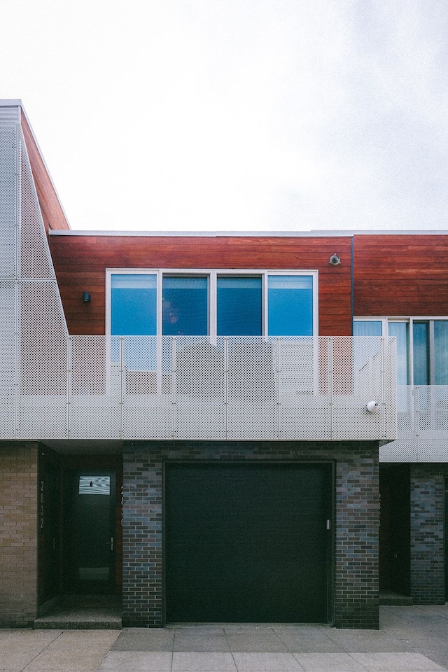 view of front of house featuring brick siding and a garage