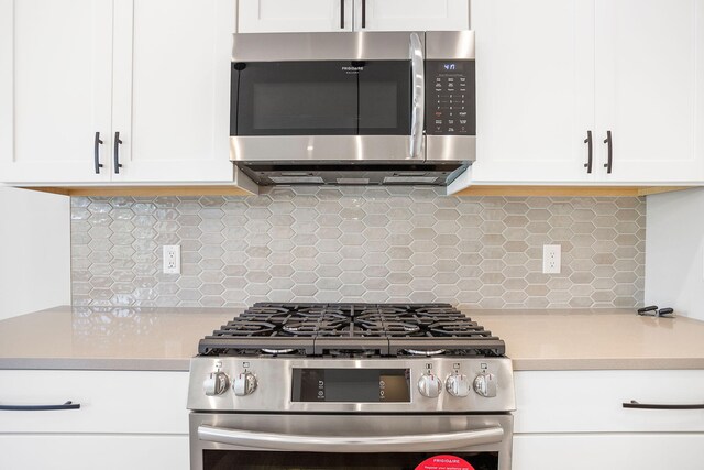 1493 Eagle Shore Ct Unit 37, Hudsonville, MI 49426 - kitchen featuring light countertops, stainless steel appliances, white cabinets, and backsplash