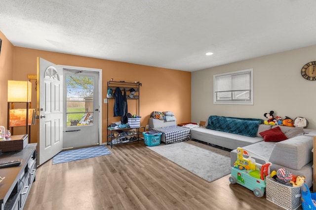 living area with recessed lighting and wood finished floors