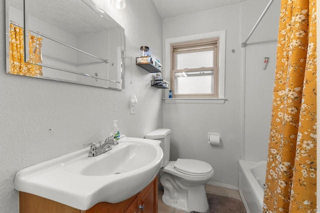 full bath with tile patterned flooring, vanity, toilet, baseboards, and shower / bath combination