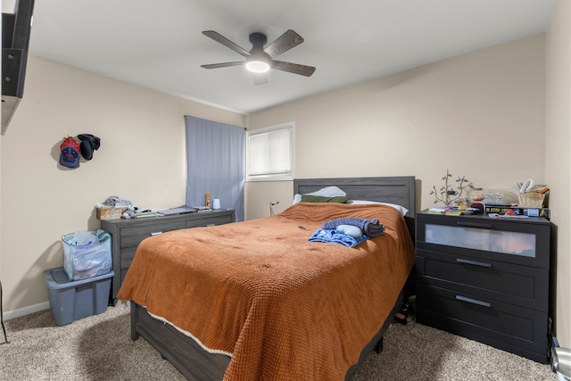 carpeted bedroom featuring baseboards and a ceiling fan