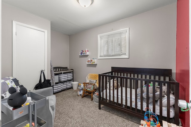 bedroom with a crib and carpet